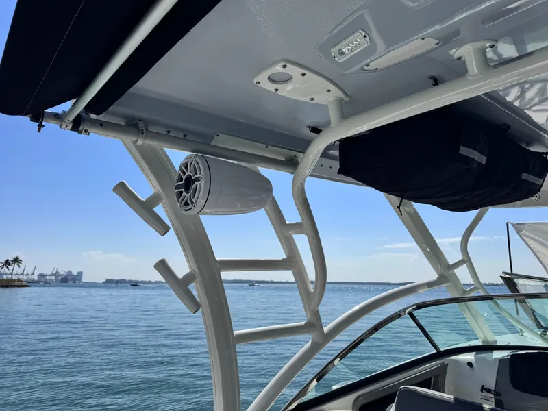 Slide: The Image of 2021 Robalo R317 Dual Console boat with speaker, ocean view, and clear blue sky. - 33