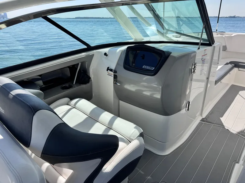 Slide: The Image of 2021 Robalo R317 Dual Console boat interior with helm, seating, and ocean view. - 35