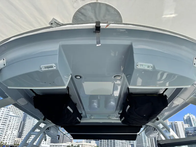 Slide: The Image of 2021 Robalo R317 Dual Console boat roof with storage compartments and city skyline background. - 41