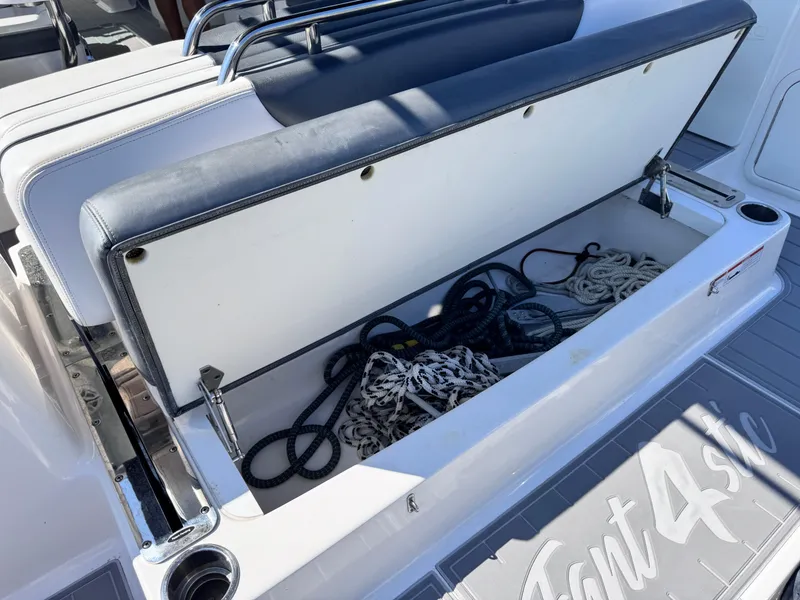 Slide: The Image of 2021 Robalo R317 Dual Console boat storage compartment with ropes inside. - 42