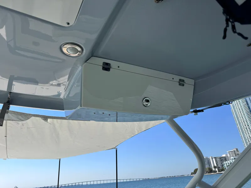 Slide: The Image of 2021 Robalo R317 Dual Console boat interior with storage compartment and ocean view. - 43