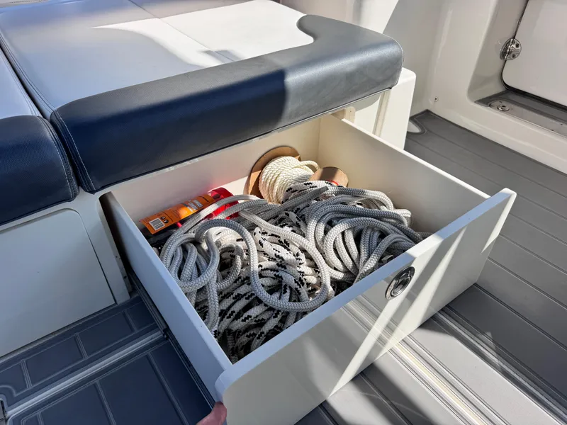 Slide: The Image of Storage drawer on 2021 Robalo R317 Dual Console with ropes and supplies. - 44