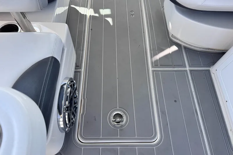 Slide: The Image of 2021 Robalo R317 Dual Console boat deck with gray flooring and seating. - 46