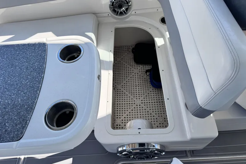 Slide: The Image of 2021 Robalo R317 Dual Console boat interior with storage compartment and cup holders. - 47
