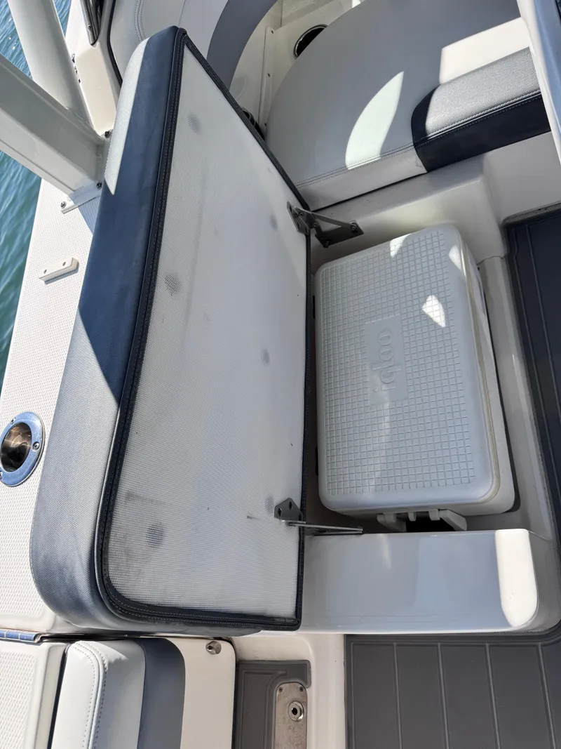 Slide: The Image of 2021 Robalo R317 Dual Console boat seat with storage compartment and cooler. - 49