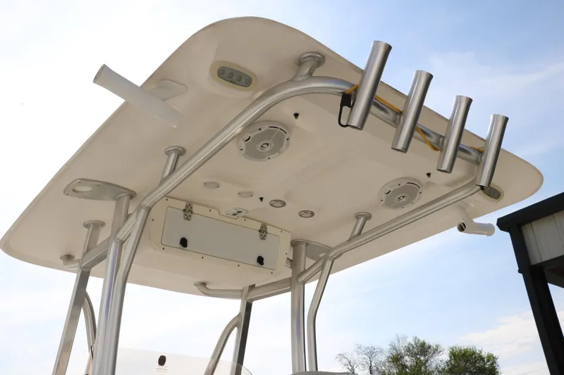 Slide: The Image of 2017 Sea Hunt BX22BR boat T-top with rod holders and speakers under a clear sky. - 17