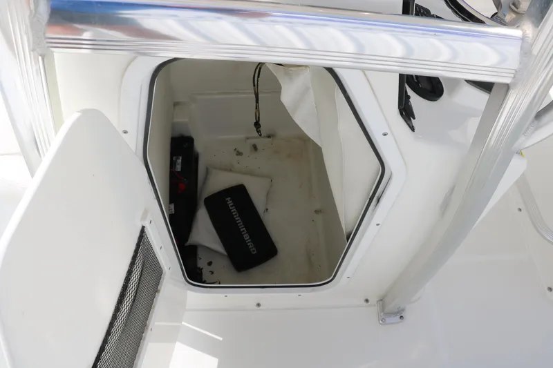 Slide: The Image of 2017 Sea Hunt BX22BR boat storage compartment with equipment inside. - 22