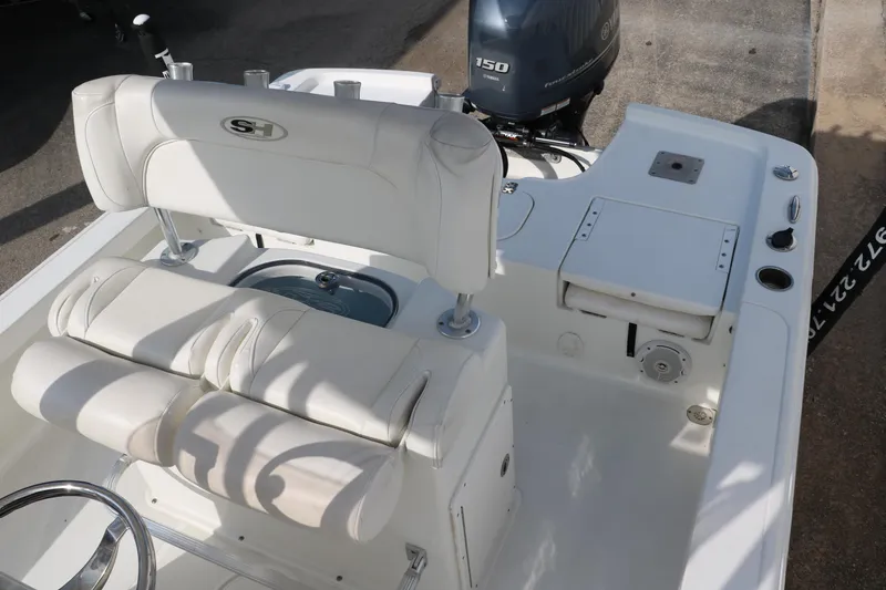 Slide: The Image of 2017 Sea Hunt BX22BR boat interior with white seating and Yamaha 150 engine. - 23