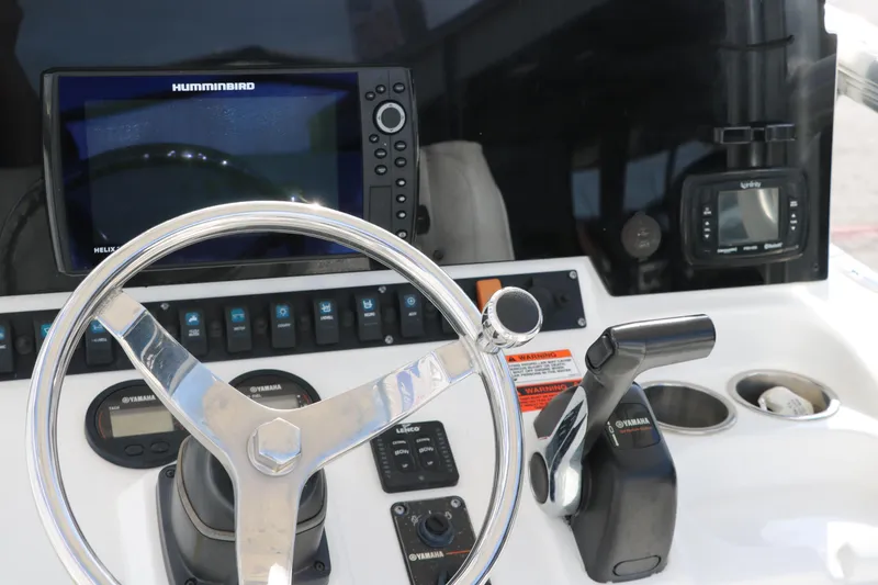 Slide: The Image of 2017 Sea Hunt BX22BR boat dashboard with steering wheel, controls, and navigation equipment. - 29