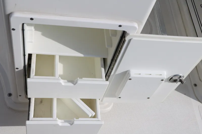 Slide: The Image of Open storage compartment with drawers on a 2017 Sea Hunt BX22BR boat. - 32