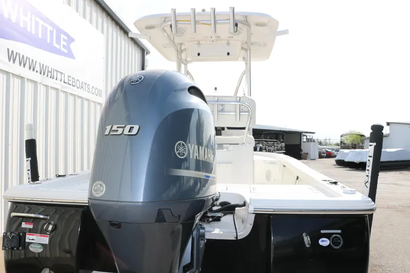 Slide: The Image of 2017 Sea Hunt BX22BR boat with Yamaha 150 engine, docked near Whittle Boats sign. - 5
