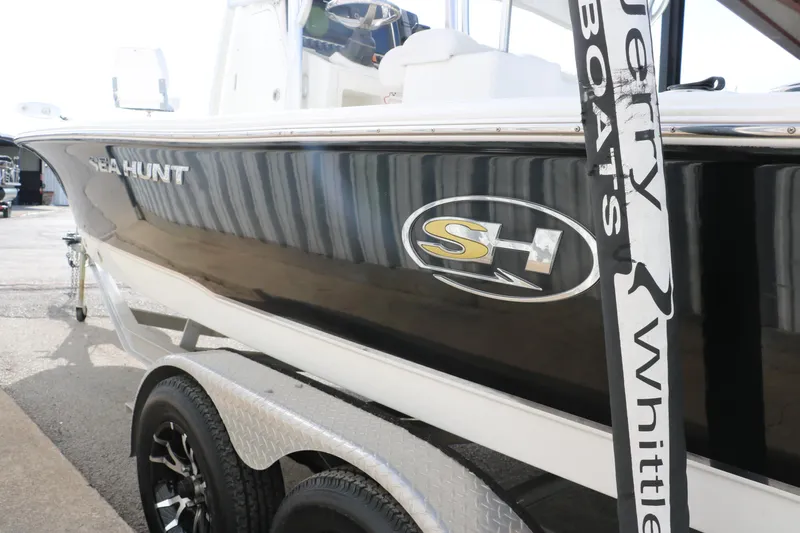 Slide: The Image of 2017 Sea Hunt BX22BR boat on trailer, side view with logo visible. - 8