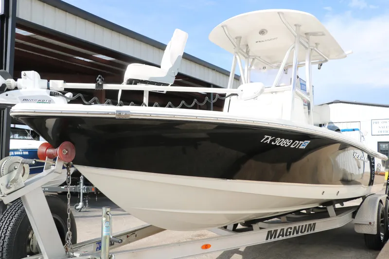 Slide: The Image of 2017 Sea Hunt BX22BR boat on Magnum trailer, parked outdoors. - 9