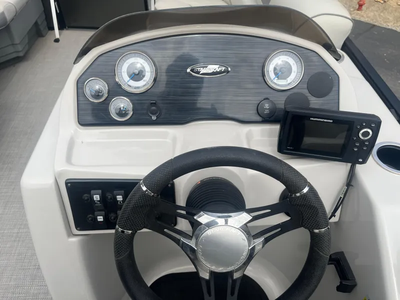 Slide: The Image of 2019 Starcraft EXS 3 boat dashboard with steering wheel and control panel. - 14