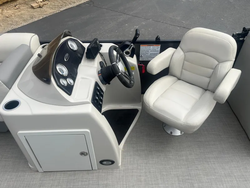 Slide: The Image of 2019 Starcraft EXS 3 boat interior with steering console and white captain's chair. - 17