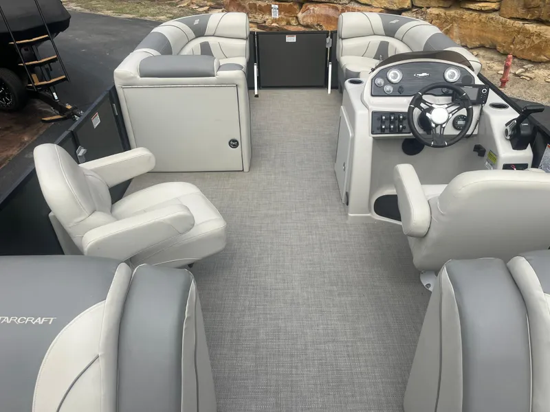 Slide: The Image of 2019 Starcraft EXS 3 pontoon boat interior with plush seating and modern helm. - 19