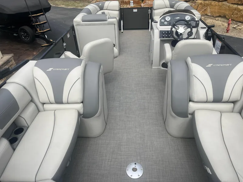 Slide: The Image of 2019 Starcraft EXS 3 pontoon boat interior with gray seating and steering console. - 20