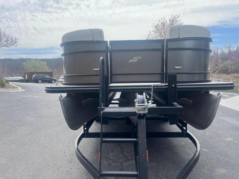 Slide: The Image of 2019 Starcraft EXS 3 pontoon boat on trailer, parked outdoors under cloudy sky. - 3