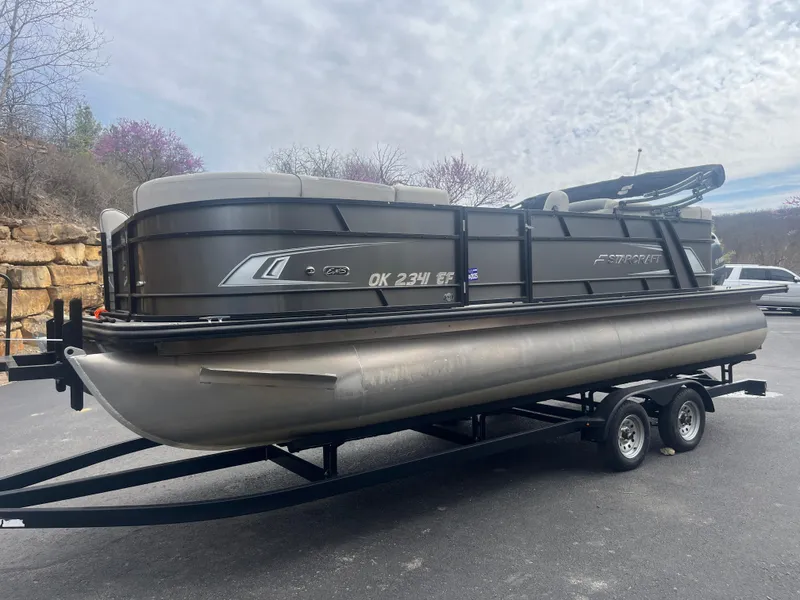 Slide: The Image of 2019 Starcraft EXS 3 pontoon boat on trailer, parked outdoors. - 4
