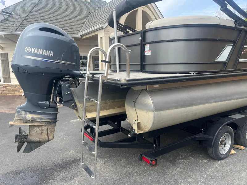 Slide: The Image of 2019 Starcraft EXS 3 pontoon boat with Yamaha outboard motor on trailer. - 5