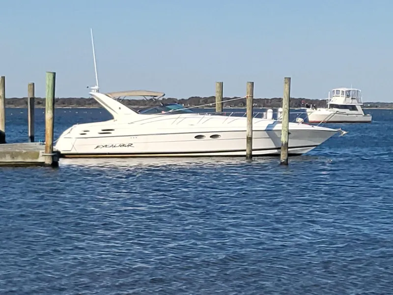 The Image of 2002 Wellcraft 38 Excalibur yacht docked on calm water. - 0