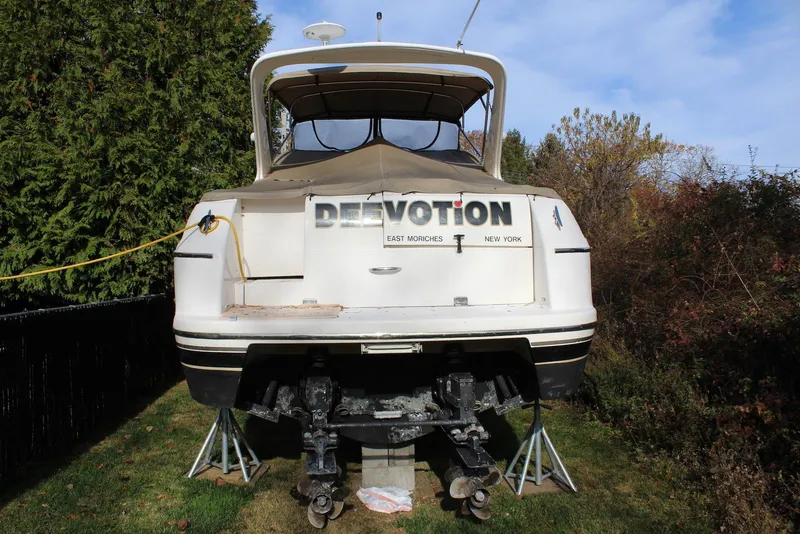 Slide: The Image of 2002 Wellcraft 38 Excalibur boat on stands, rear view, outdoors. - 10