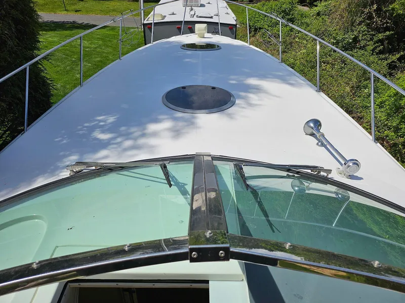 Slide: The Image of 2002 Wellcraft 38 Excalibur boat deck with railing and hatch, viewed from the cockpit. - 12