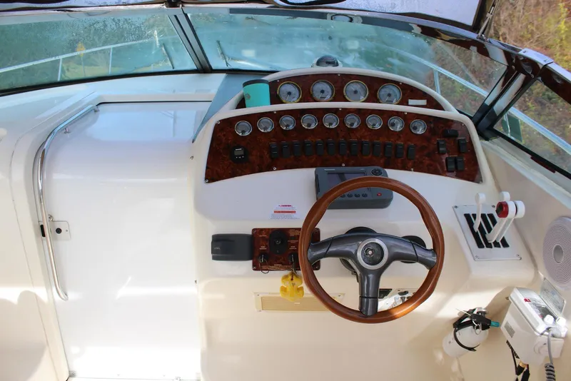 Slide: The Image of 2002 Wellcraft 38 Excalibur boat dashboard with steering wheel and instrument panel. - 15