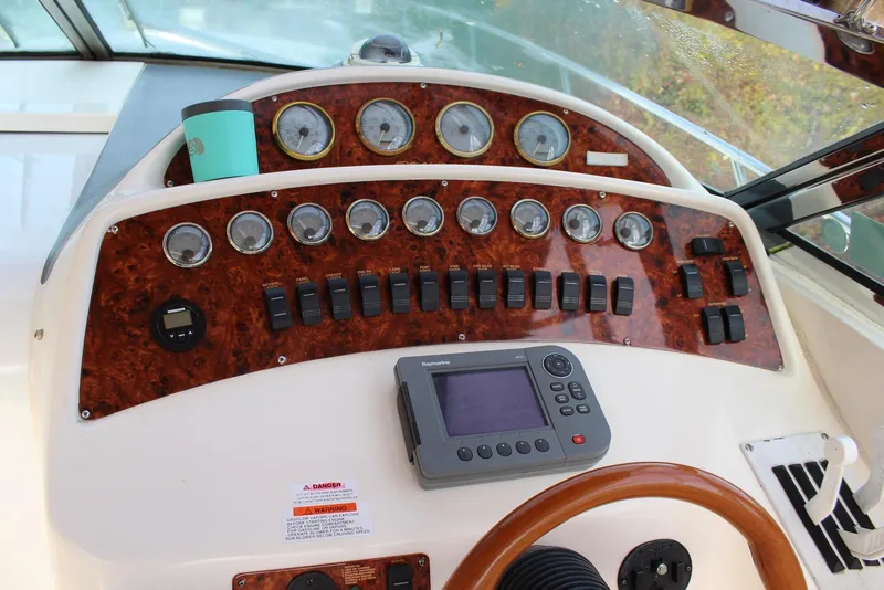Slide: The Image of Dashboard of a 2002 Wellcraft 38 Excalibur boat with gauges and controls. - 16