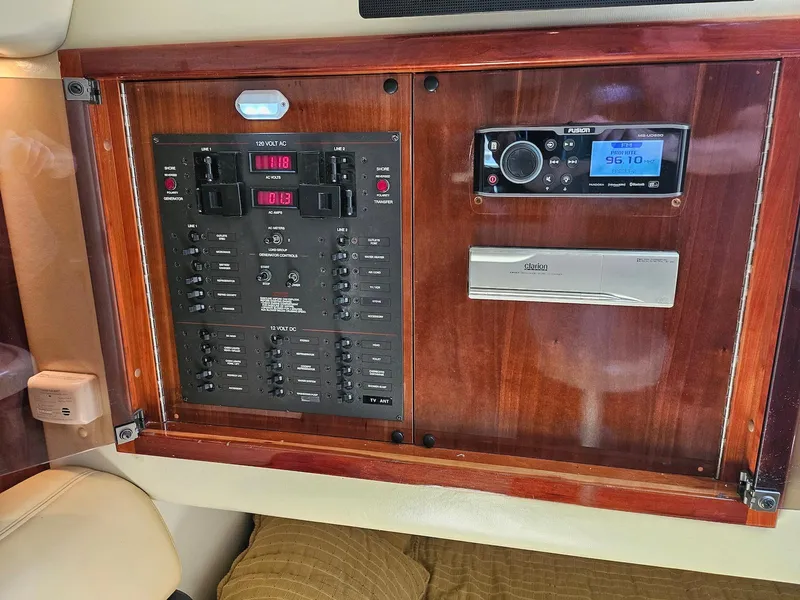 Slide: The Image of Control panel of a 2002 Wellcraft 38 Excalibur boat with radio and switches. - 6