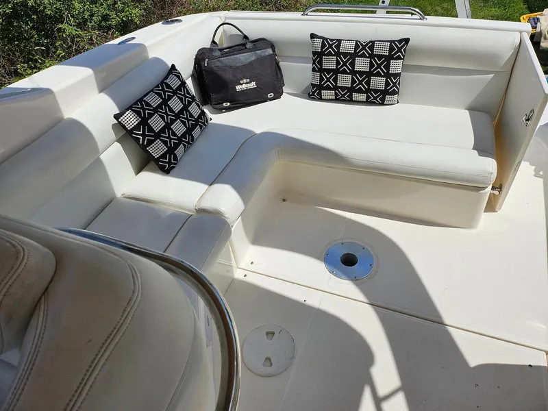 Slide: The Image of 2002 Wellcraft 38 Excalibur boat interior with white seating and decorative pillows. - 9