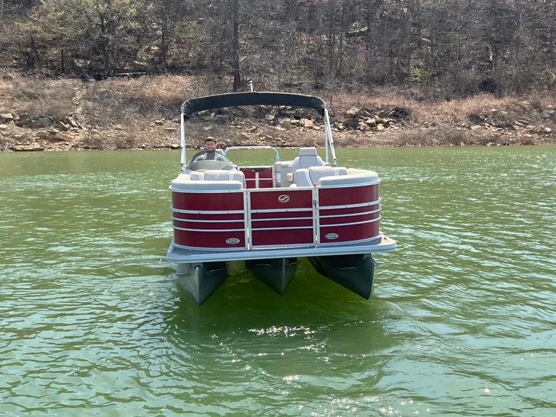 Slide: The Image of 2014 Starcraft SLS3 pontoon boat on a calm lake with wooded shoreline. - 5