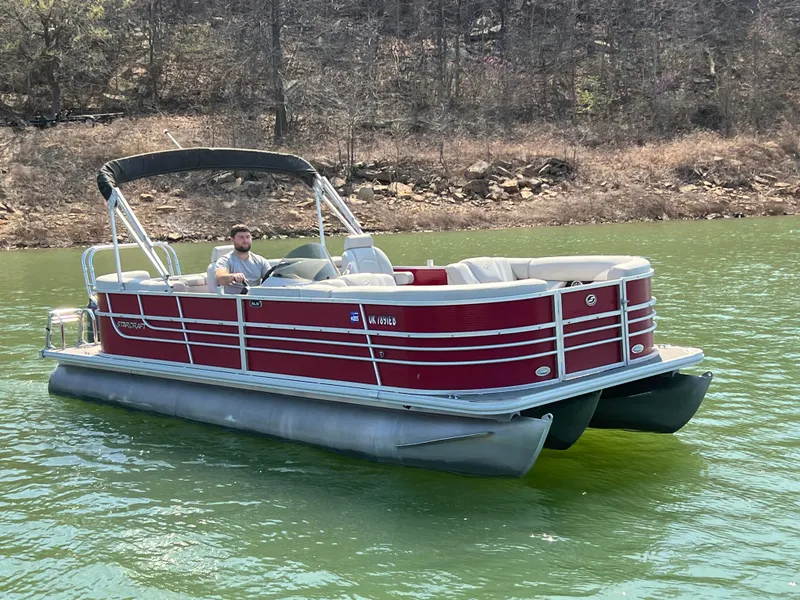 Slide: The Image of 2014 Starcraft SLS3 pontoon boat on a lake with a person steering. - 7