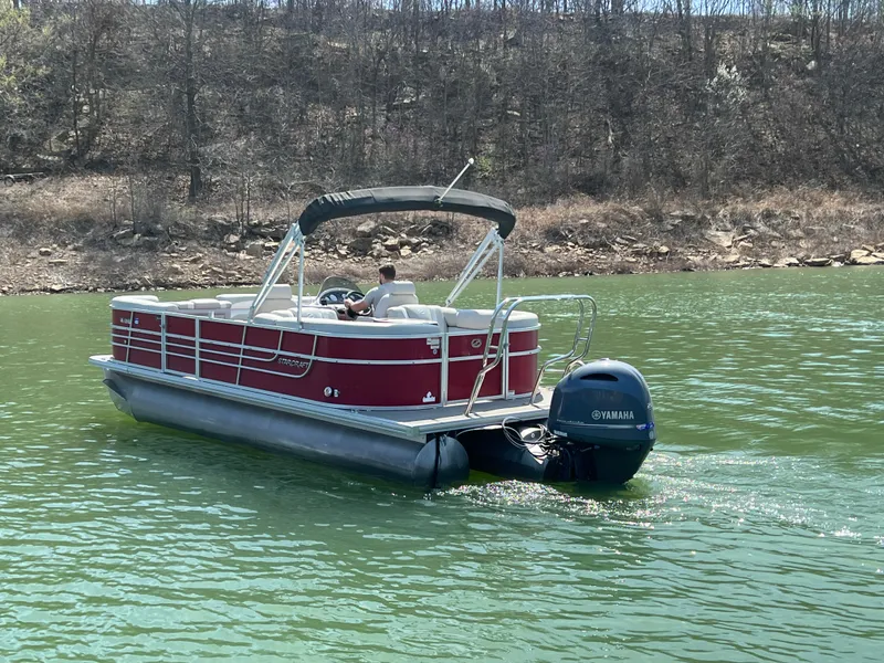 Slide: The Image of 2014 Starcraft SLS3 pontoon boat on a lake with Yamaha outboard motor. - 9