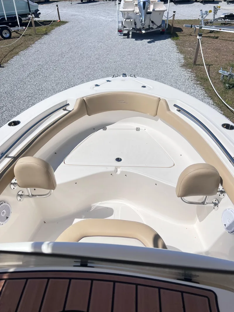 Slide: The Image of 2019 Pioneer 202 Islander boat interior with beige seating and white deck. - 6