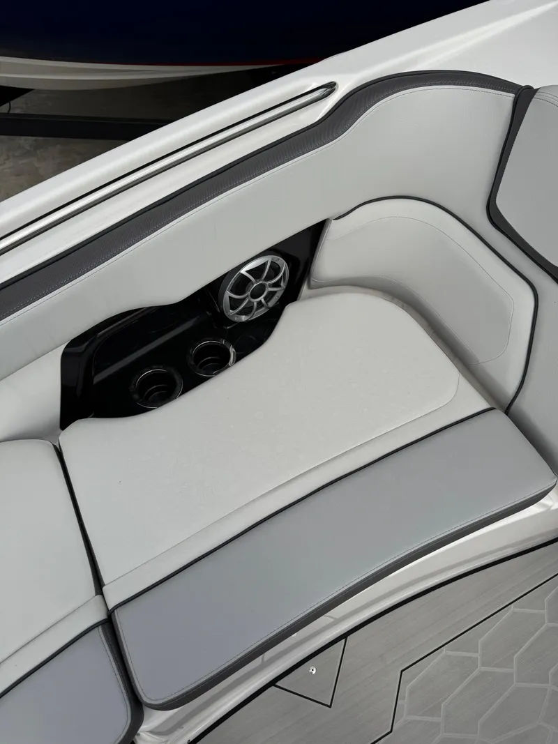 Slide: The Image of 2024 Yamaha Boats 252XE interior seating with speaker and cup holders. - 6