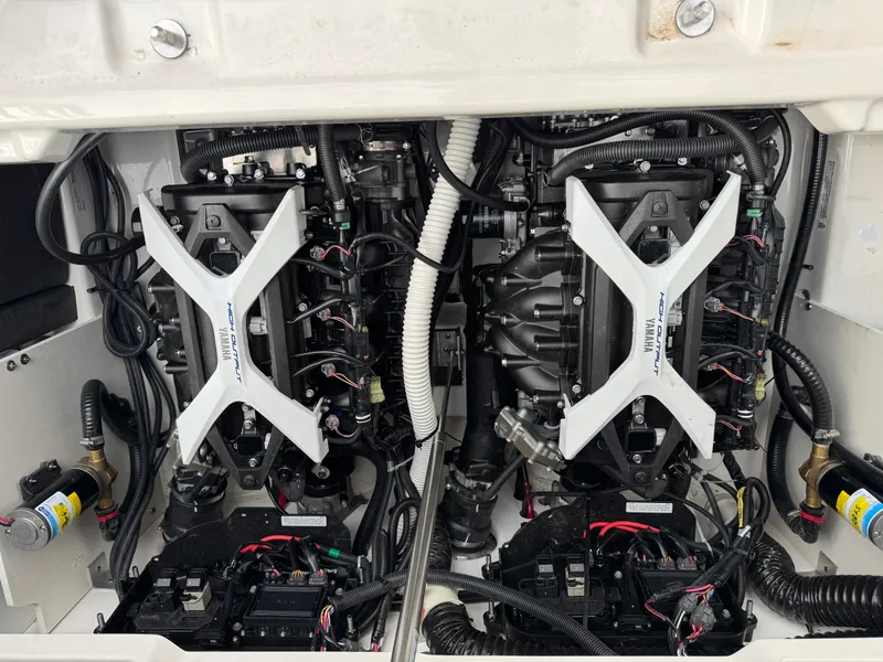 Slide: The Image of Engine compartment of a 2024 Yamaha Boats 252XE, showcasing dual engines and wiring. - 8
