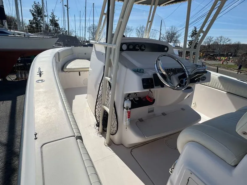 Slide: The Image of 2000 Grady-White Bimini 306 boat interior with steering console and seating. - 10