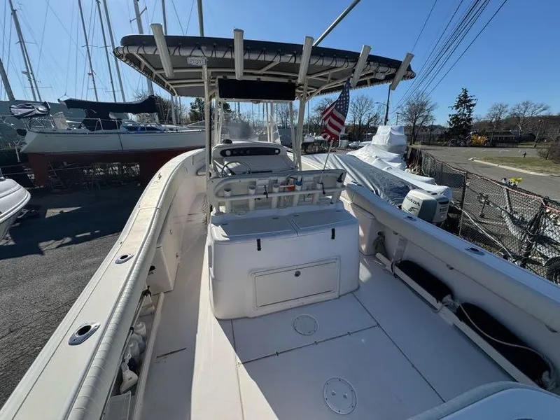 Slide: The Image of 2000 Grady-White Bimini 306 boat with T-top, docked near sailboats. - 16