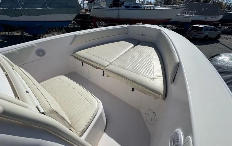 Slide: The Image of 2000 Grady-White Bimini 306 boat with cushioned seating in the bow area. - 21
