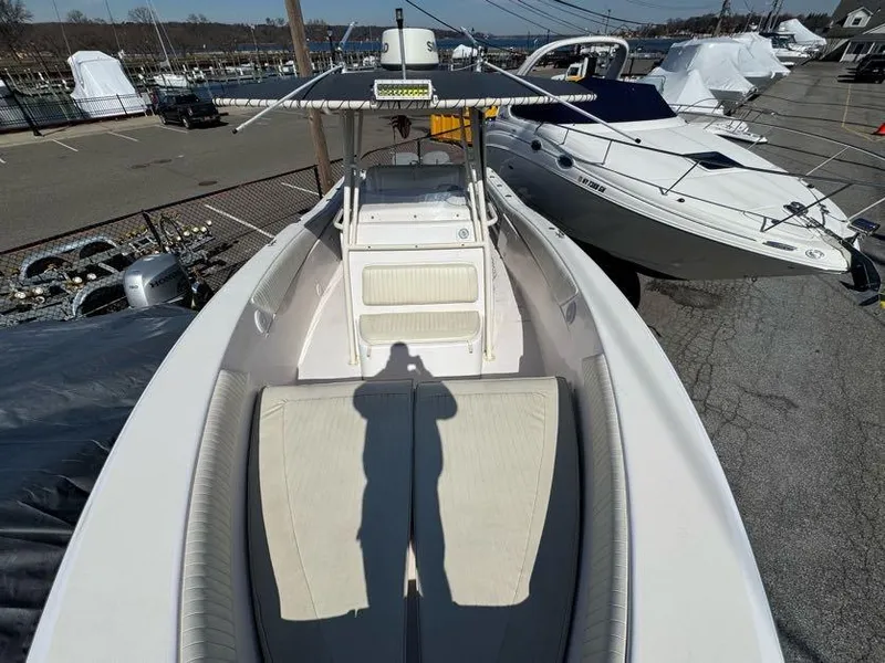 Slide: The Image of 2000 Grady-White Bimini 306 boat docked, featuring spacious deck and seating area. - 23