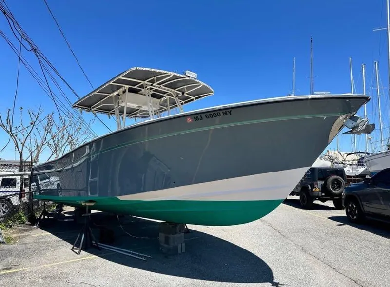 Slide: The Image of 2000 Grady-White Bimini 306 boat on display in a marina setting. - 3