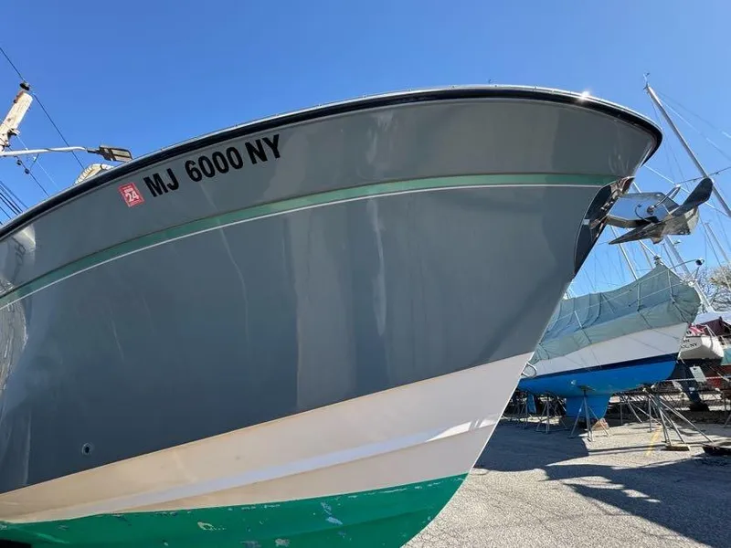 Slide: The Image of 2000 Grady-White Bimini 306 boat in dry dock, side view. - 32