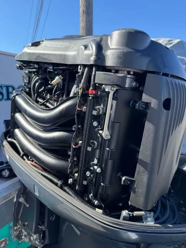 Slide: The Image of Close-up of a Grady-White Bimini 306 outboard engine, 2000 model, under bright blue sky. - 34