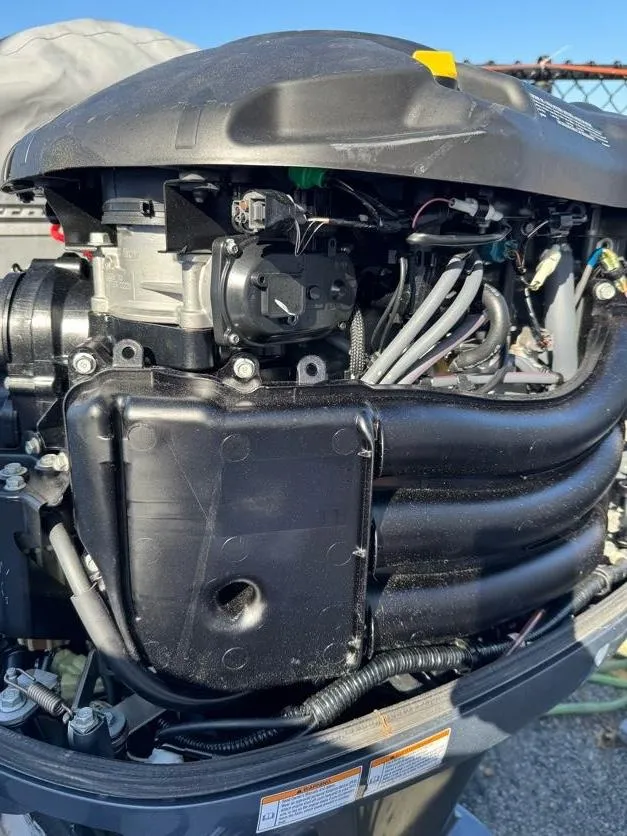 Slide: The Image of Close-up of a Grady-White Bimini 306 2000 outboard motor, showcasing engine details. - 35