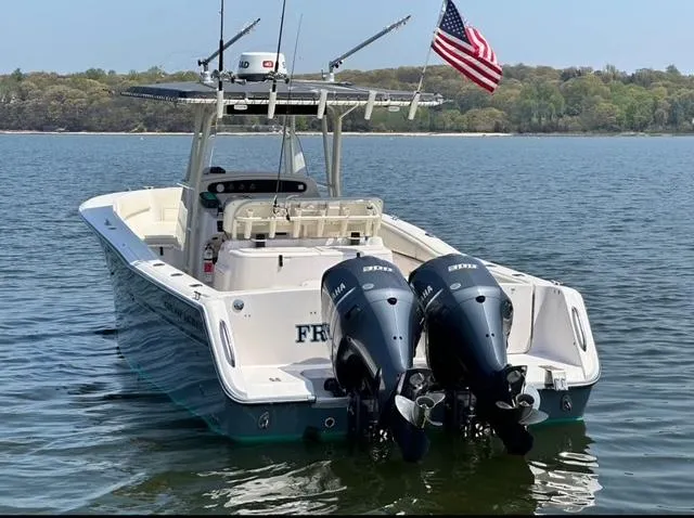 Slide: The Image of Grady-White Bimini 306 boat, 2000 model, with dual engines on a calm lake. - 5