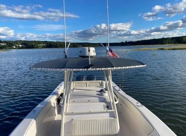 Slide: The Image of Grady-White Bimini 306 boat on serene lake under blue sky, 2000 model. - 6