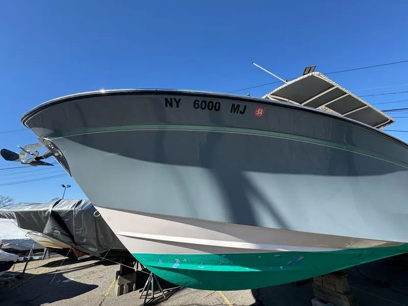 Slide: The Image of 2000 Grady-White Bimini 306 boat with NY registration, docked under clear blue sky. - 7