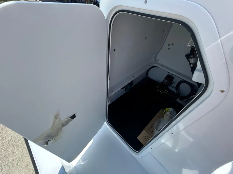 Slide: The Image of Open storage compartment in 2025 Shallow Sport 24 Sport boat. - 11