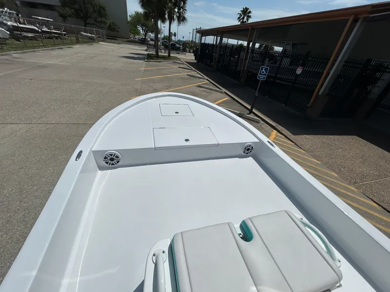 Slide: The Image of 2025 Shallow Sport 24 Sport boat, spacious deck, parked outdoors. - 12